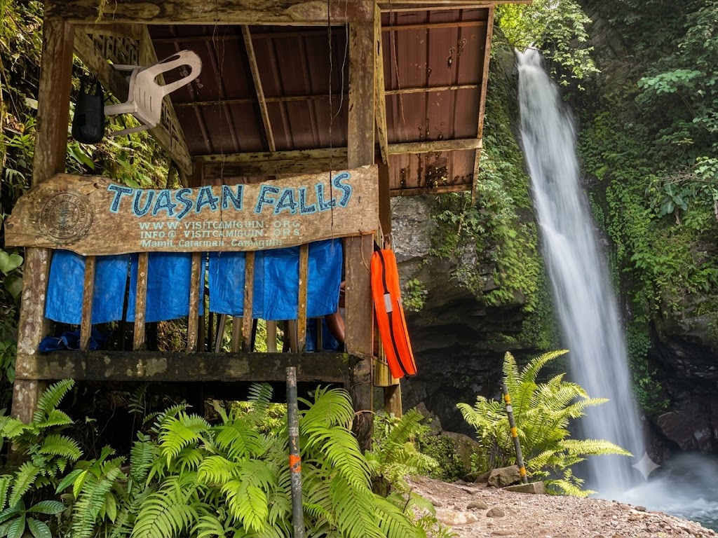 Crystal clear waters cascading down the rocky face of Tuasan Falls